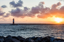 Germany, Mecklenburg-West Pomerania, Warnemunde, Lighthouse And Sea At Sunset