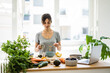 © Robijn Page/Westend61 - Woman preparing healthy food in her kitchen