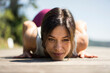 © Robijn Page/Westend61 - Mature woman practicing yoga in summer on a jetty