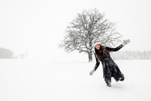 Happy Young Woman Having Fun In Winter Landscape