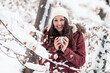 © Wilfried Feder/Westend61 - Portrait of happy young woman with hot beverage in winter