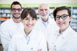 © Pavel Horak/Westend61 - Portrait of smiling pharmacist team in pharmacy