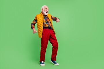 Sticker - Photo of positive good mood senior gentleman wear yellow vest dancing smiling isolated green color background