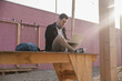 © Uwe Umst√§tter/Westend61 - Young man sitting on platform using laptop