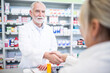 © Pavel Horak/Westend61 - Pharmacist and customer shaking hands in pharmacy