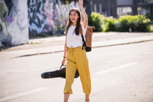 Happy Young Woman With Violin Case On The Street Waving
