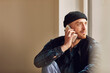 © Maya Claussen/Westend61 - Man refurbishing shop location, sitting on windowsill, talking on the phone