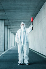 Man Wearing Protective Clothing Holding A Signaling Disk