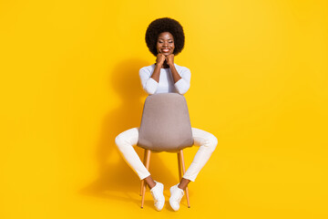 Poster - Full size photo of impressed cute brunette short hair lady hands chin wear white pullover trousers sneakers isolated on yellow background