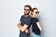 © SHOTPRIME STUDIO - a young couple in black t-shirt sunglasses posing light background
