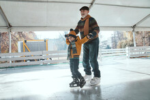 Grandfather And Grandson On The Ice Rink, Ice Skating