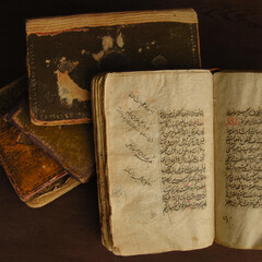 Wall Mural - Stack of open ancient books in Arabic. Old Arabic manuscripts and texts. Top view