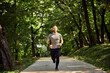 © Dangubic/Westend61 - Sporty man running on forest path