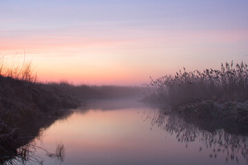 Wall Mural - morning fog over the river red dawn