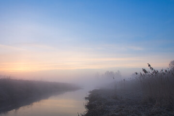 Wall Mural - morning fog over the river red dawn