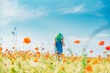 © Jana M√§nz/Westend61 - Pre-adolescent boy holding globe in poppy field against blue sky on sunny day