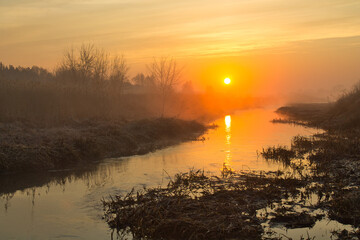 Wall Mural - morning fog over the river red dawn
