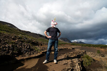 Man With Unicorn Mask Standing With Hand On Hip At Laugarvatnshellir, Reydarbarmur, Iceland