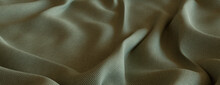 Seasonal Autumn Background With Fine Woven Fabric. Ripples And Folds Form A Wavy Grey Green Texture.