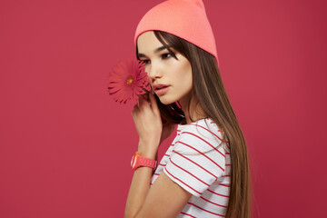 Wall Mural - pretty brunette wearing pink hat flower posing isolated background