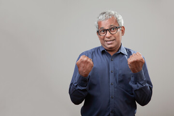 Wall Mural - Senior man of Indian origin with a cheering expression