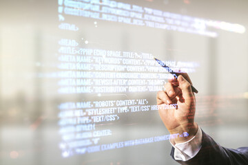 Poster - Male hand with pen working with abstract virtual coding concept on blurred office background. Multiexposure