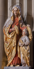 VIENNA, AUSTIRA - JUNI 24, 2021: The carved polychrome statue of St. Ann in church Familienkirche.