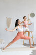 © Вадим Каштанов - Mom and daughter doing yoga exercise together. Paired workout. Couples yoga.