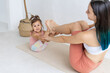 © Вадим Каштанов - Mom and daughter doing exercise together. Paired workout. Couples yoga.
