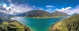 Fototapeta Na ścianę - Drone panorama over turquoise lake Weissensee in Austrian province of Carinthia during daytime