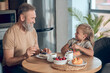 © zinkevych - Dad and his daughter having breakfast together at home