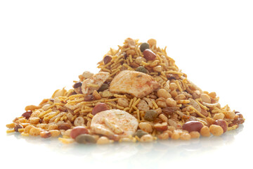 Close-up of Hot spicy NavRatan mixture snacks, made with, potato chips, peanuts, besan sev, red chili. (snacks), Indian spicy snacks (Namkeen), in a pile or heap, isolated over white background