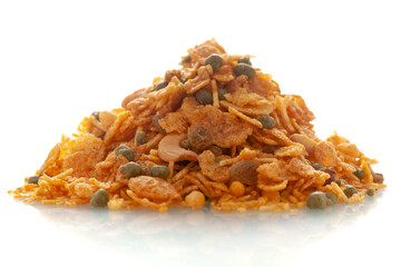 Close-up of cornflakes mixture Indian namkeen (snacks),  Indian spicy snacks (Namkeen), in a pile or heap, isolated over white background