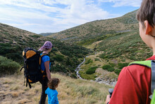 Mother And Children Hiking In The Mountains. Near The Manzanares River, Madrid, Spain