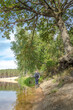 © alexey351 - Fisherman on the bank of a beautiful river.