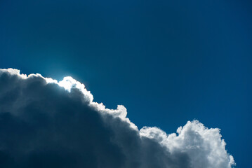 Wall Mural - .Download Preview.Share.Add to Likebox.Cloudscape with the sun shining through the clouds in a blue sky.