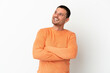 © luismolinero - Brazilian man over isolated white background looking up while smiling