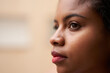 © CarlosBarquero - Close up portrait of attractive African American woman's eyes looking outside through window.