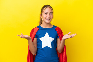 Wall Mural - Super Hero little girl isolated on yellow background with shocked facial expression