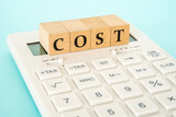 Fototapeta  - Concept of cost calculation (calculator and the word “COST”)