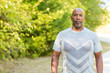 © digitalskillet1 - Mature African American man taking a walk outside.