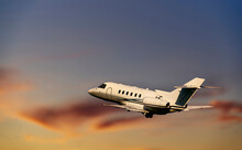Private Airplane Jetliner Flying Above Clouds In Beautiful Sunset Light. Travel And Business Concept. Backside View