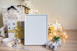 Fototapeta Tulipany - Portrait white picture frame mockup with christmas gifts, boken lights