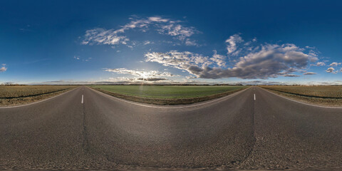 Wall Mural - seamless hdri 360 panorama view on asphalt road among fields in summer evening with awesome clouds i