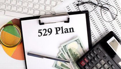 Poster - Text 529 PLAN on Office desk table with keyboard, dollars,calculator ,supplies,analysis chart on the white background.