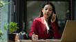 © bongkarn - Young asian business woman having a formal business talk on the phone