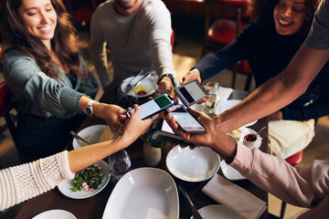 Friends splitting the bill in restaurant