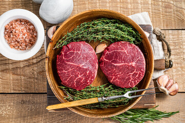 Fresh meat Fillet Mignon steaks from beef tenderloin. wooden background. Top view