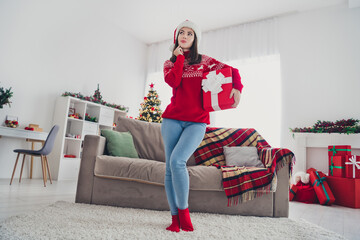 Poster - Full size photo of young minded girl hand touch chin think plan how to celebrate new year hold gift box indoors