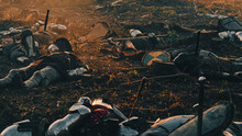 After Epic Battle Bodies Of Dead And Murdered Medieval Knights Lying On Battlefield. Warrior Soldiers Fallen In Conflict, War, Conquest. Cinematic Dramatic Historical Reenactment.